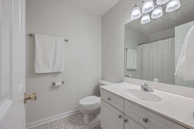 bathroom featuring toilet, tile patterned flooring, and vanity