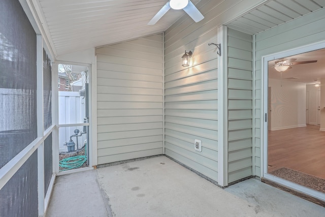 unfurnished sunroom featuring ceiling fan and lofted ceiling