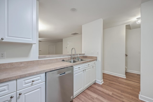 kitchen featuring light wood-type flooring, dishwasher, white cabinets, and sink