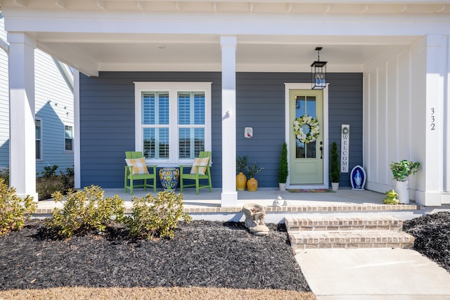 view of exterior entry with covered porch