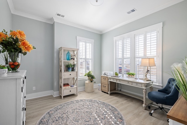 sitting room with crown molding and light hardwood / wood-style flooring