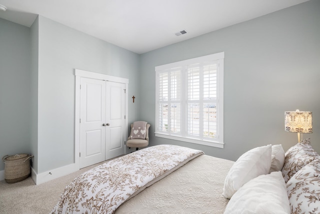 carpeted bedroom featuring a closet