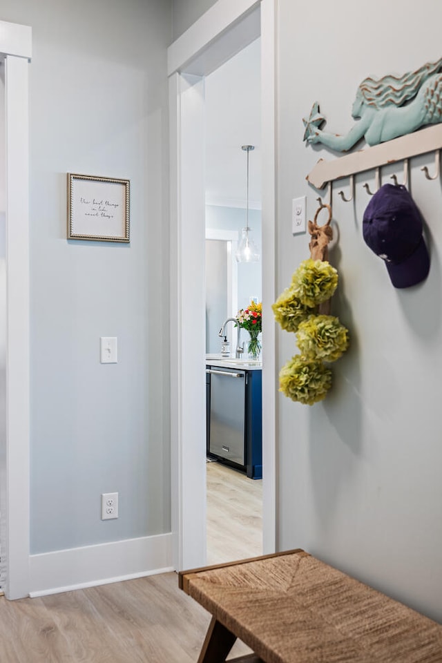 mudroom featuring sink and light hardwood / wood-style floors