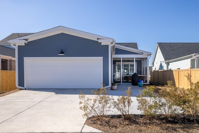 view of front facade with a garage and a sunroom