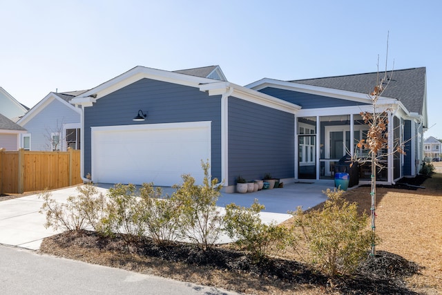 view of front of home with a garage and a sunroom