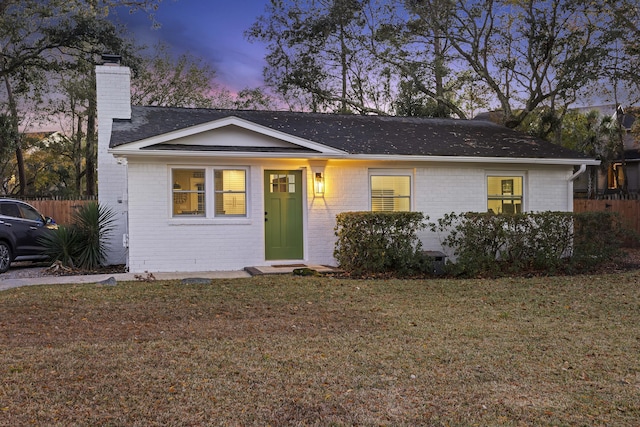 ranch-style home featuring a yard