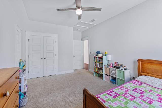 bedroom featuring carpet floors, a closet, visible vents, attic access, and ceiling fan