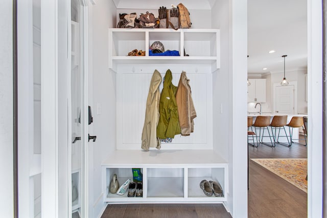 mudroom featuring dark wood-type flooring and recessed lighting