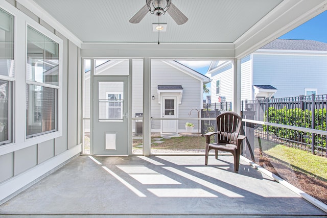 sunroom / solarium featuring ceiling fan