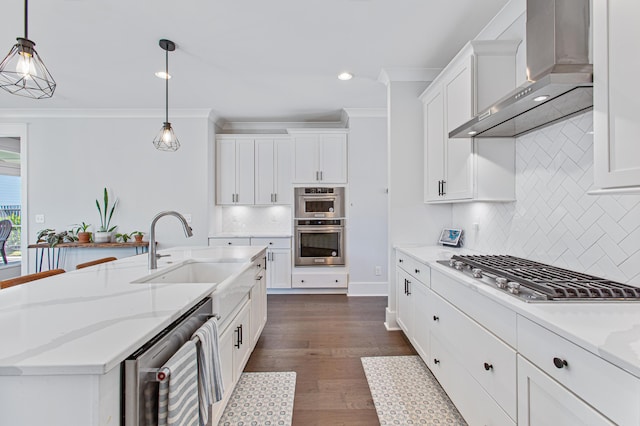 kitchen featuring beverage cooler, appliances with stainless steel finishes, wall chimney range hood, white cabinetry, and a sink