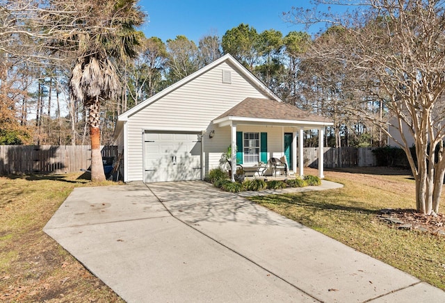 view of front of home featuring a front lawn, a porch, and a garage