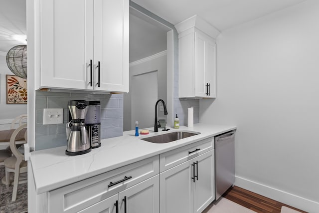1990 Butternut St, Charleston, SC 29414 - kitchen featuring dishwasher, wood finished floors, white cabinets, tasteful backsplash, and light stone countertops