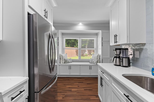 1990 Butternut St, Charleston, SC 29414 - kitchen featuring freestanding refrigerator, dark wood finished floors, white cabinets, backsplash, and ornamental molding