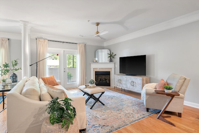 living area featuring ornamental molding and wood finished floors
