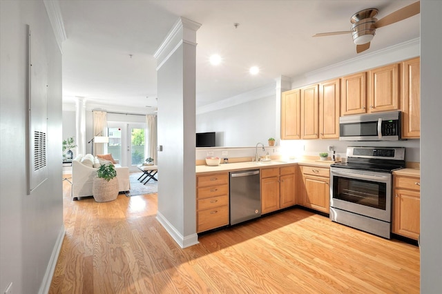 kitchen with crown molding, light brown cabinetry, ceiling fan, light wood finished floors, and stainless steel appliances