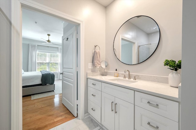 ensuite bathroom featuring vanity, marble finish floor, and ensuite bath