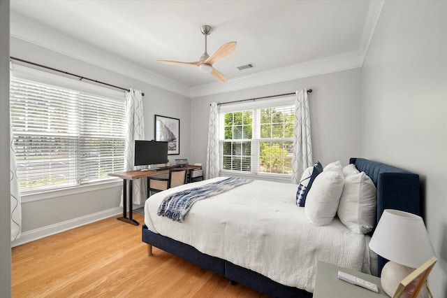 bedroom with visible vents, crown molding, light wood-style floors, baseboards, and ceiling fan