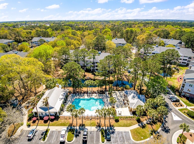 drone / aerial view with a residential view and a forest view