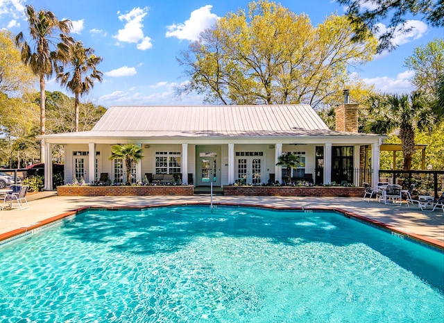 pool featuring french doors and a patio area