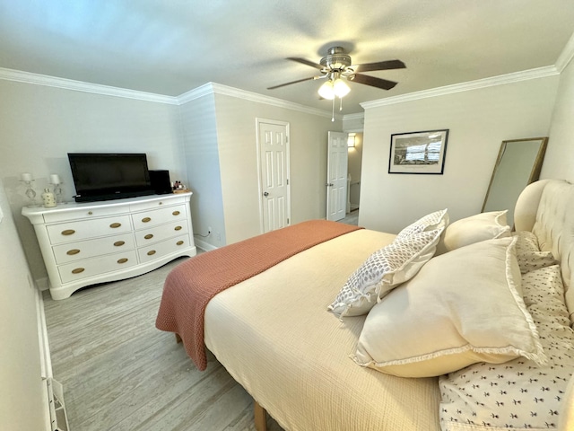 bedroom with ceiling fan, light wood-style flooring, baseboards, and ornamental molding