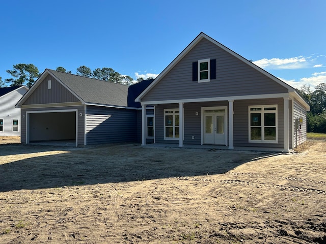 view of property with french doors and a garage