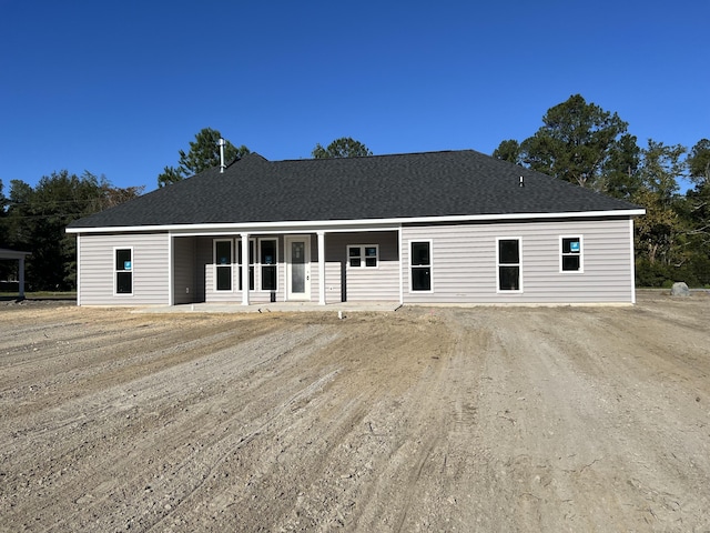 rear view of house featuring covered porch