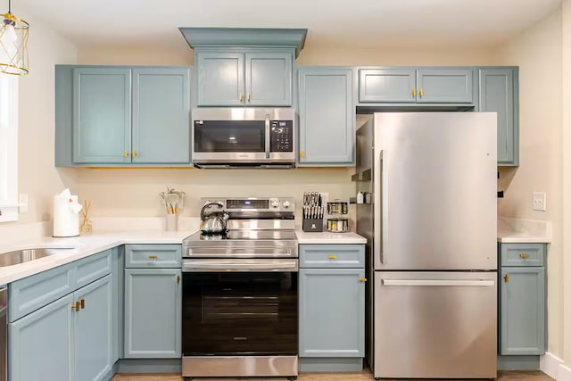 kitchen featuring stainless steel appliances and blue cabinetry