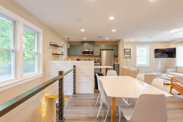 dining space featuring light wood-type flooring