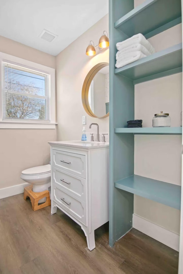 bathroom featuring hardwood / wood-style flooring, vanity, and toilet