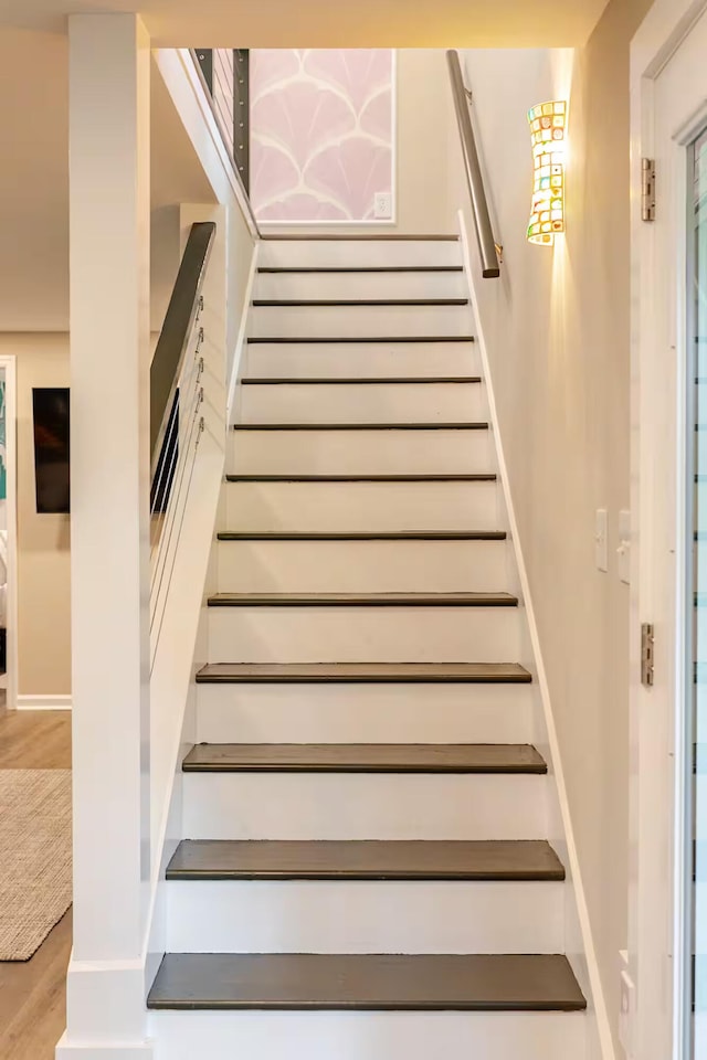 stairway with hardwood / wood-style flooring