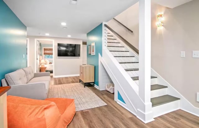 stairs featuring hardwood / wood-style floors