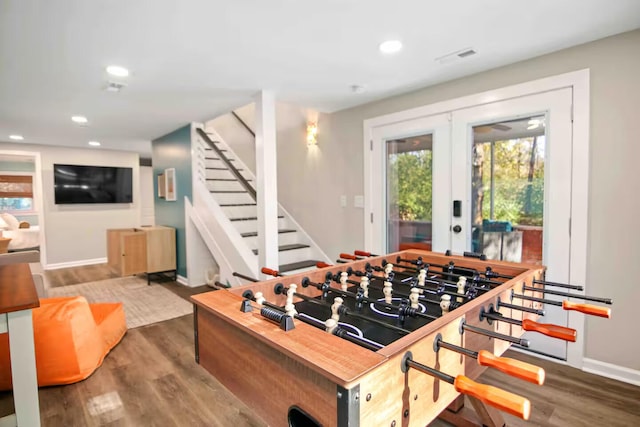 playroom with hardwood / wood-style flooring and french doors