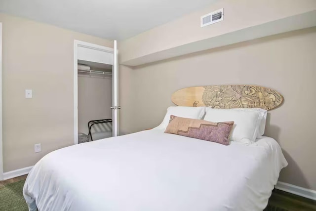 bedroom featuring dark hardwood / wood-style flooring and a closet