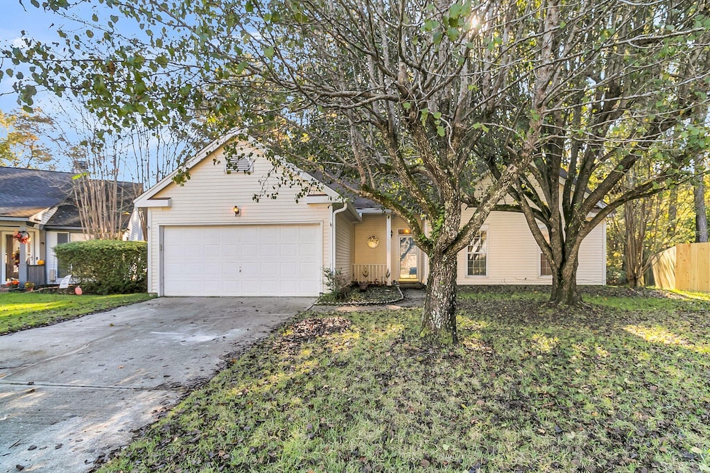 view of front of home with a front yard and a garage