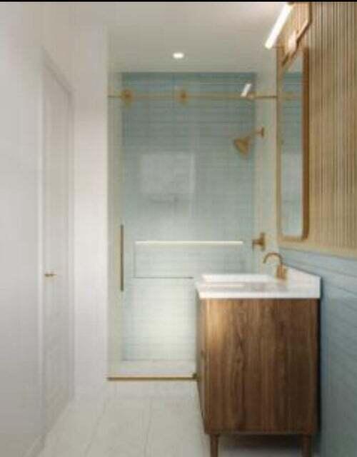 bathroom with vanity and tile walls