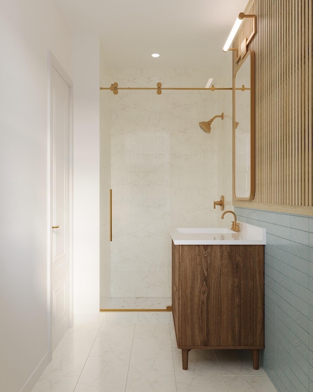 bathroom featuring vanity, tiled shower, and tile walls