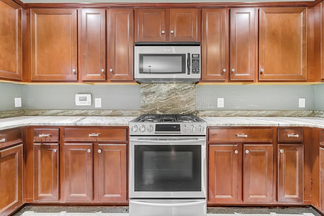 319 Deep River Rd, Summerville, SC 29486 - kitchen with light stone countertops, appliances with stainless steel finishes, and tasteful backsplash