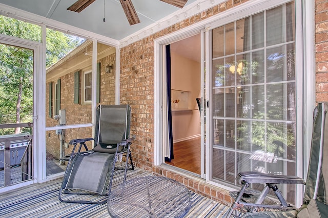 sunroom featuring ceiling fan