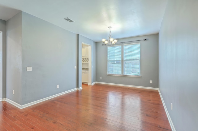 1350 Wild Goose Trl, Summerville, SC 29483 - empty room featuring a chandelier and hardwood / wood-style floors