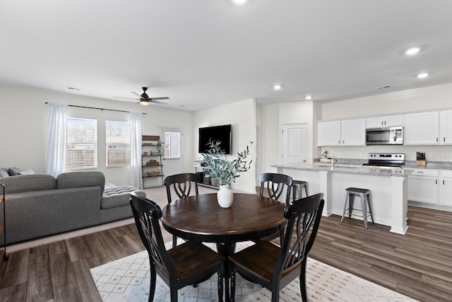 dining space featuring hardwood / wood-style flooring and ceiling fan