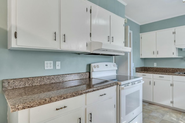 kitchen with ornamental molding, white cabinets, and electric stove