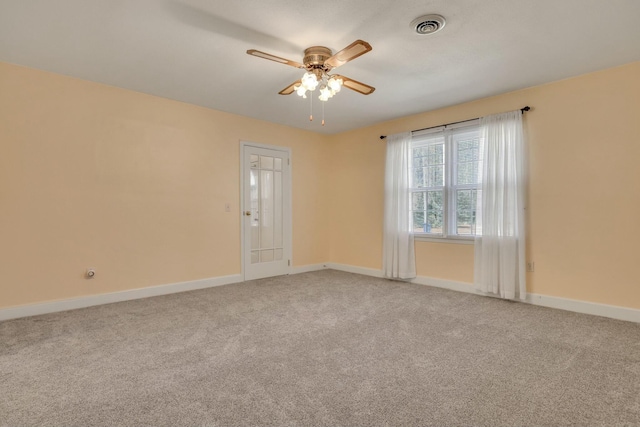 empty room featuring ceiling fan and carpet flooring