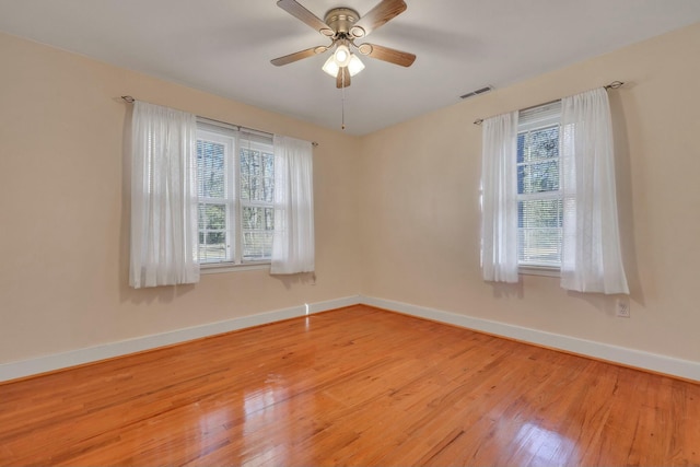 empty room with light hardwood / wood-style flooring and ceiling fan