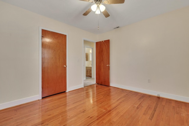 spare room featuring light hardwood / wood-style floors and ceiling fan