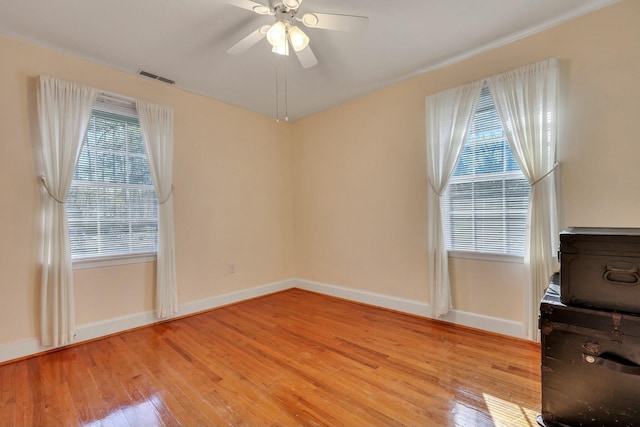 unfurnished room featuring light wood-type flooring and ceiling fan