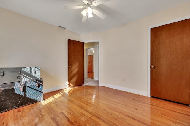 spare room featuring light hardwood / wood-style floors and ceiling fan