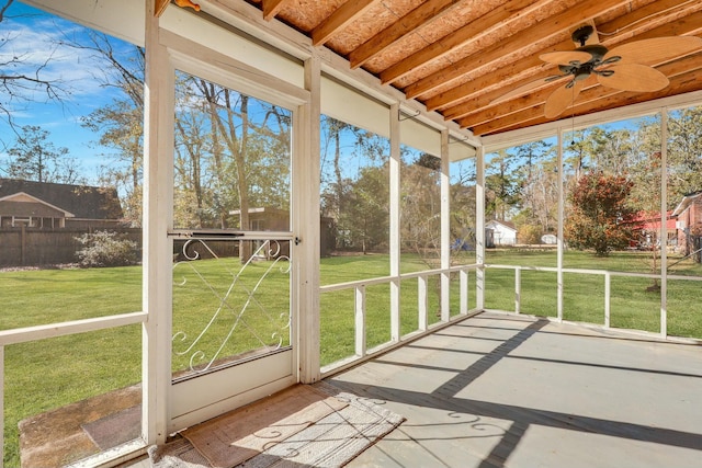 unfurnished sunroom with ceiling fan