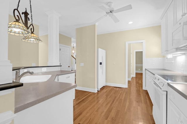 1025 Mathis Ferry Rd, Mount Pleasant, SC 29464 - kitchen with white appliances, ornate columns, ceiling fan, white cabinetry, and crown molding