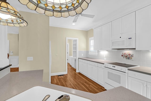 1025 Mathis Ferry Rd, Mount Pleasant, SC 29464 - kitchen with white appliances, decorative backsplash, wood finished floors, white cabinetry, and recessed lighting