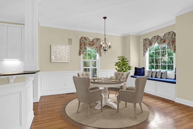 1025 Mathis Ferry Rd, Mount Pleasant, SC 29464 - dining area featuring wood finished floors, healthy amount of natural light, crown molding, a chandelier, and a wainscoted wall